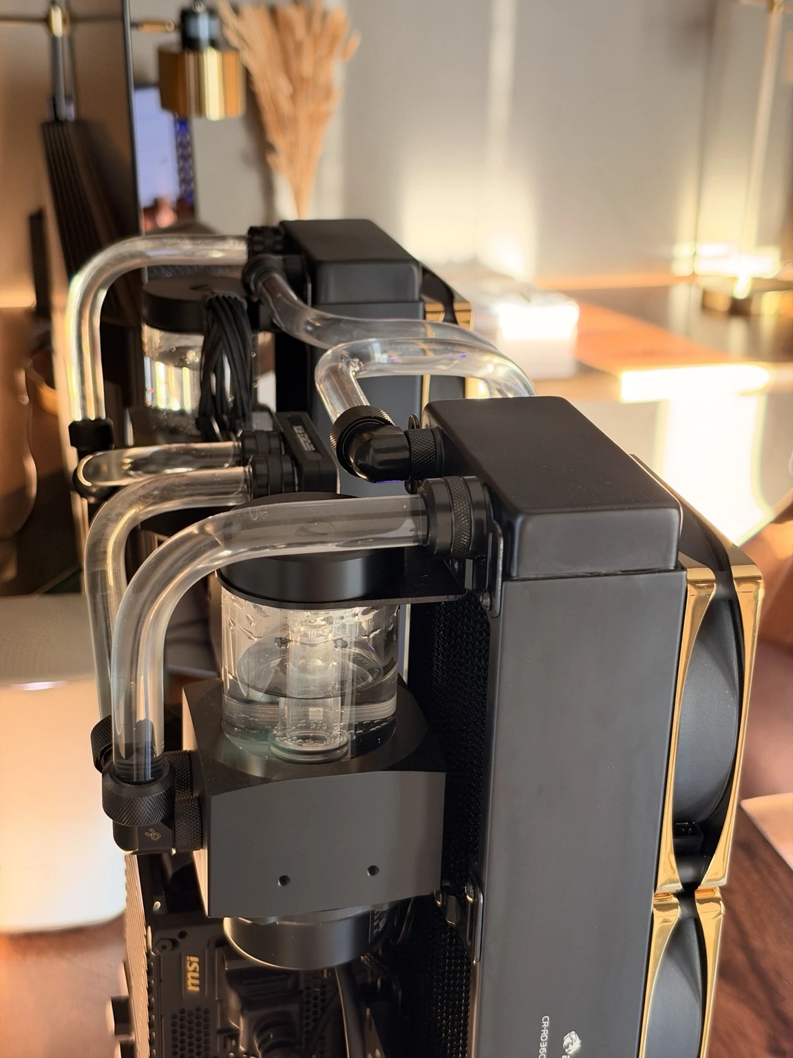 Close-up of the 5090 build’s reservoirs, radiator arrangement, and custom tubing